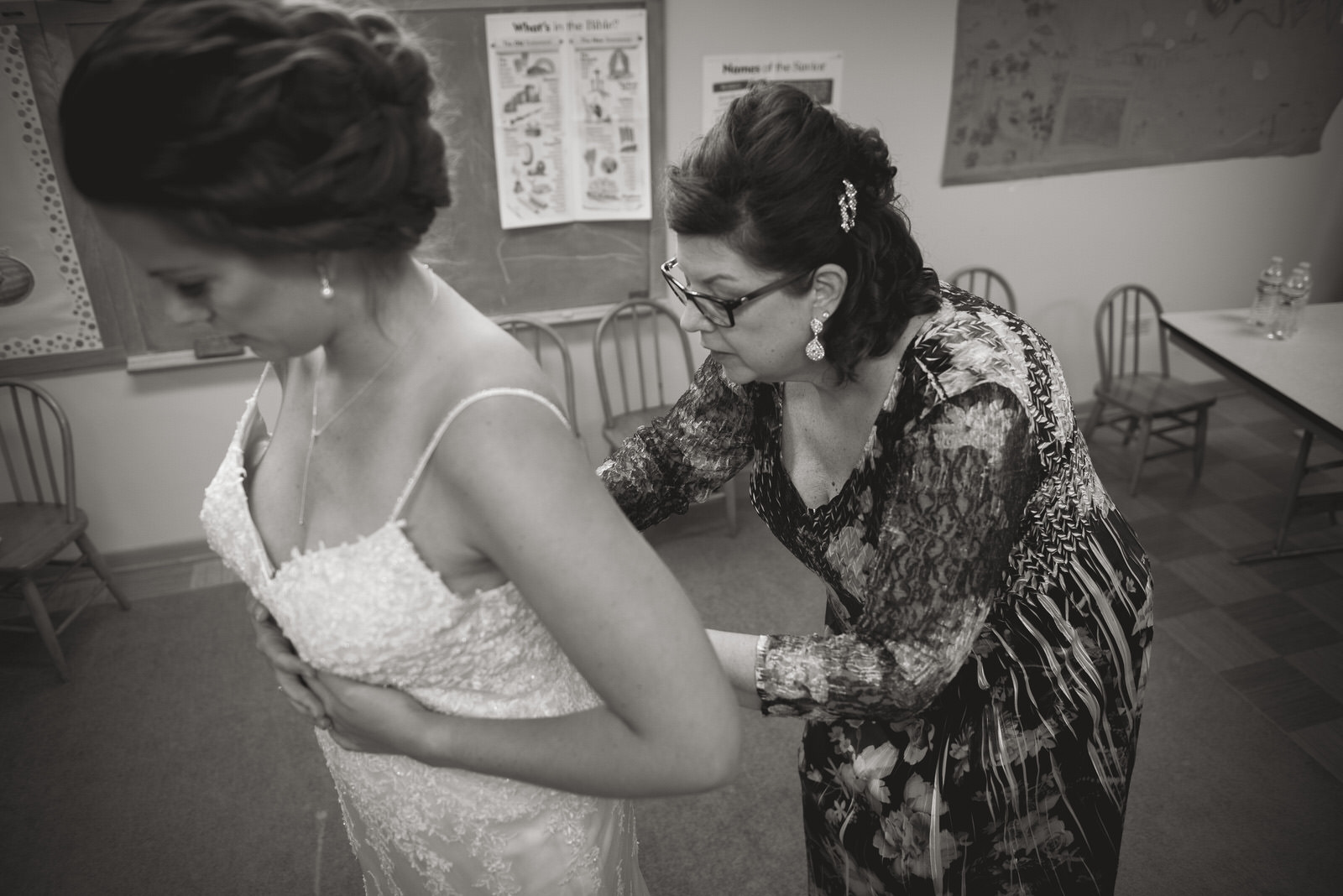 mother of bride putting on wedding dress in nashport ohio