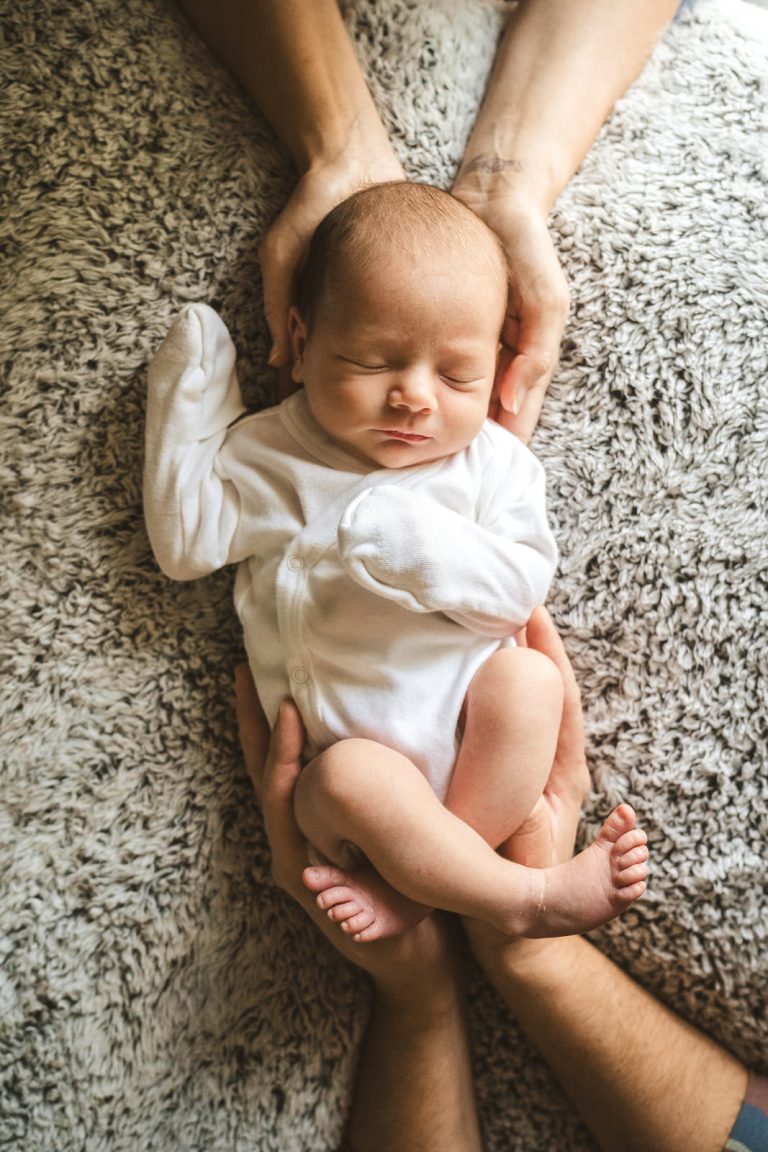 newborn baby sleeping during family photos